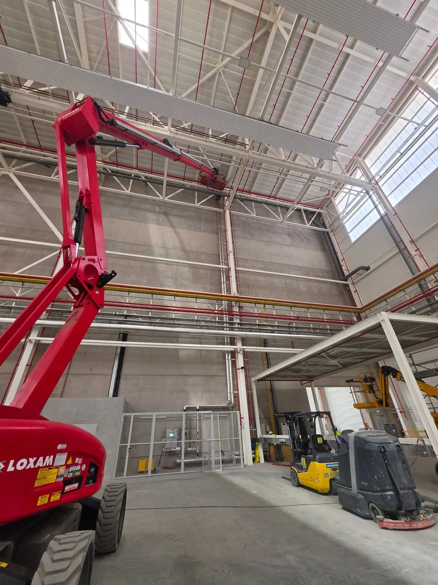 Accès au poste de travail en sous-charpente par nacelle PEMP dans un hangar industriel près de Toulouse