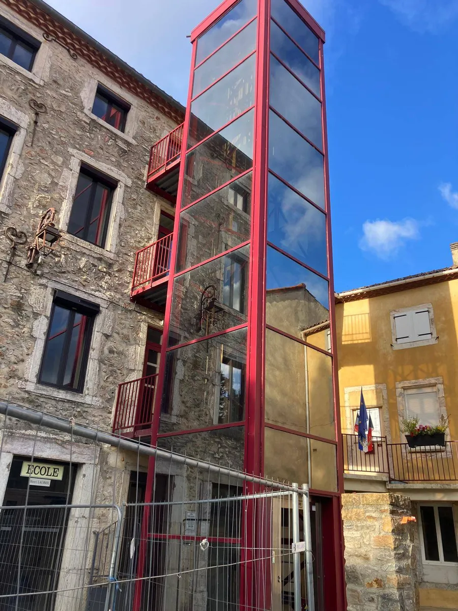 Ascenseur panoramique de la mairie de Premian apres nettoyage des vitres et de la structure metallique par 2KM